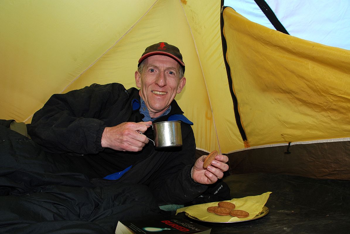 02 Jerome Ryan Enjoying Afternoon Tea And Cookies At Kharka On Way To Mesokanto La The trail climbs up the valley from Thini, keeping to the left and away from the Nepalese army in the restricted military area. We stayed the night at a kharka at 3460m. Jerome Ryan enjoyed afternoon tea and cookies in his tent.